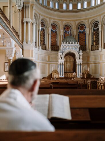 man praying at synagogue
