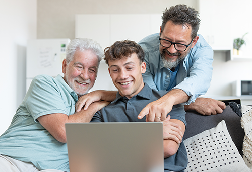 Intergenerational family around computer